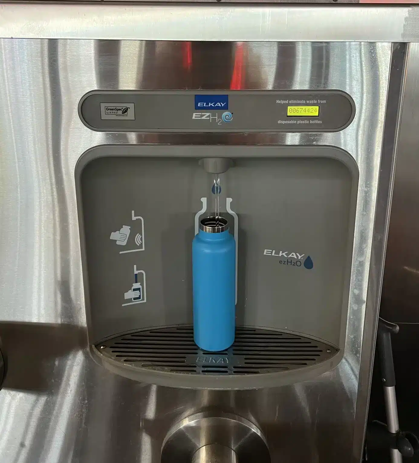 A Hydroflask being refilled at a Water Bottle Refill Station at Cosmic Ray's Starlight Cafe in Magic Kingdom - Disney World - Guide2WDW