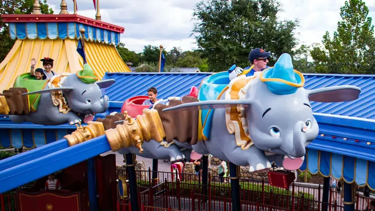 Kids Riding Dumbo - Guide2WDW's Disney World Guide to saving money with kids