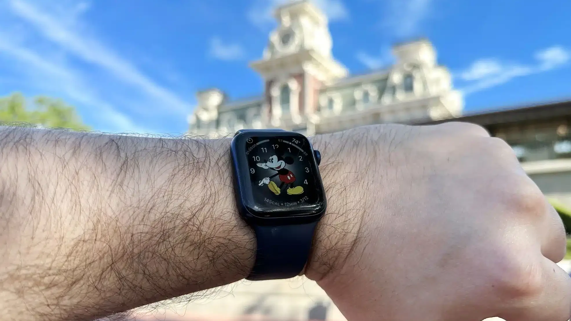 Wearing an Apple Watch at Disney World in front of the Magic Kingdom Train Station - Guide2WDW