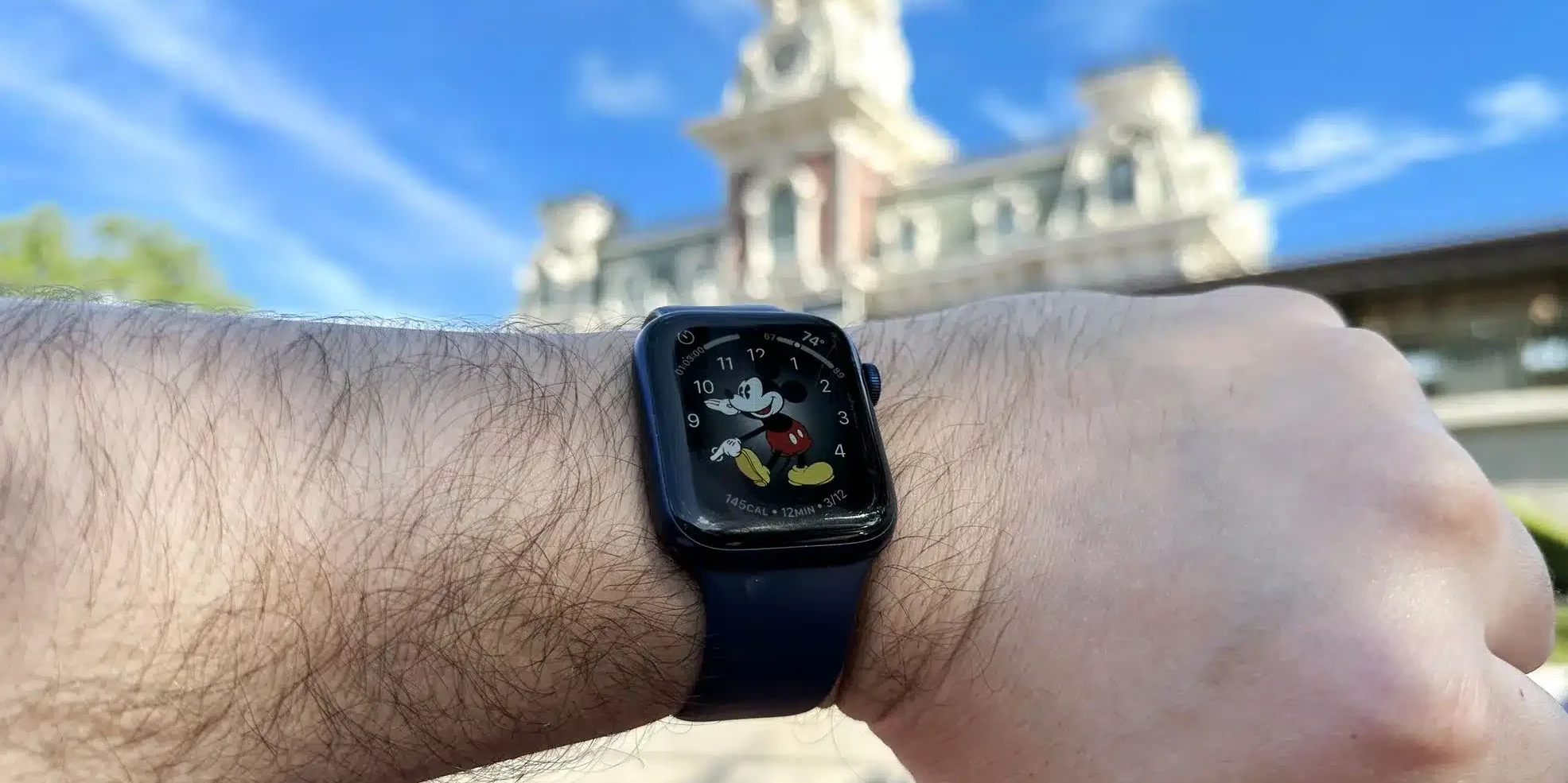 Wearing an Apple Watch at Disney World in front of the Magic Kingdom Train Station - Guide2WDW