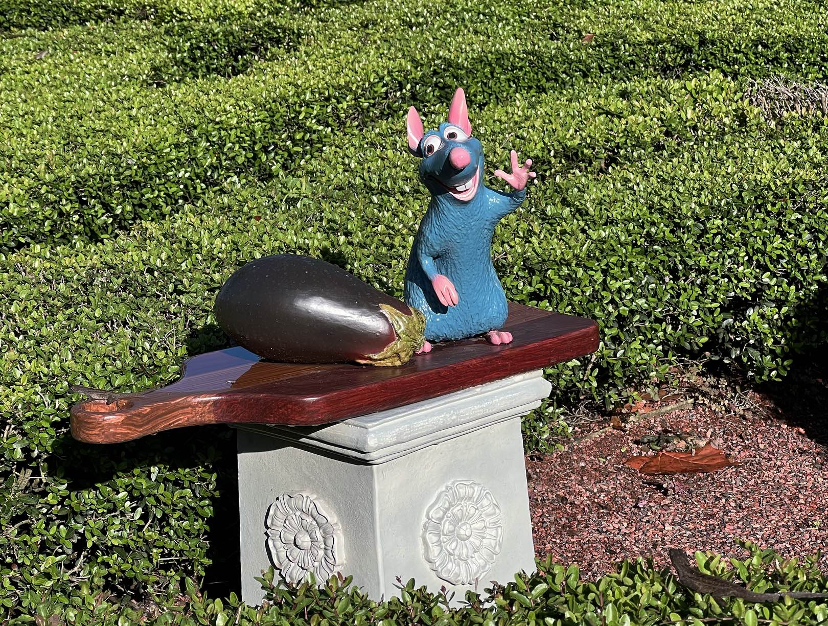 Remy the rat and an eggplant statue at Remy's Hide and Squeak scavenger hunt at the EPCOT Food & Wine Festival at Disney World